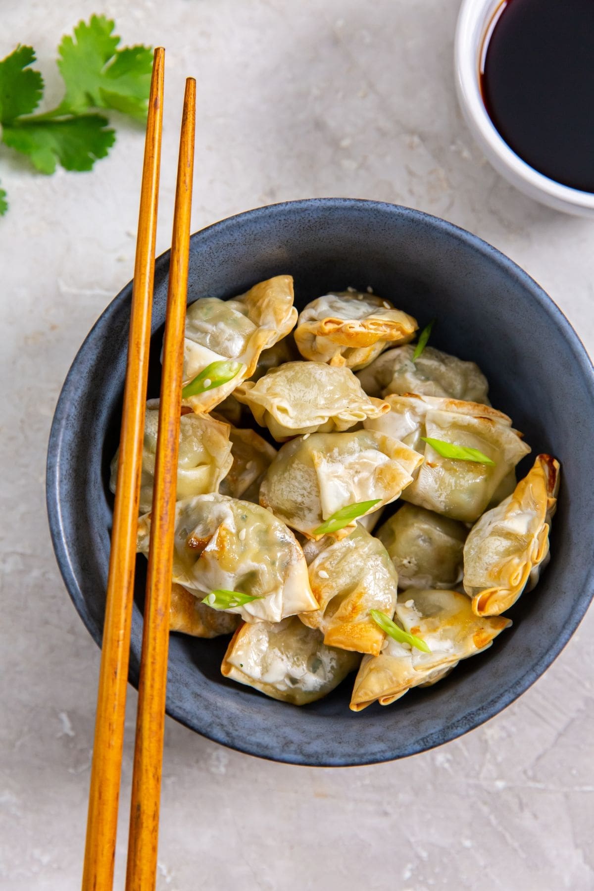 blue bowl with wontons inside