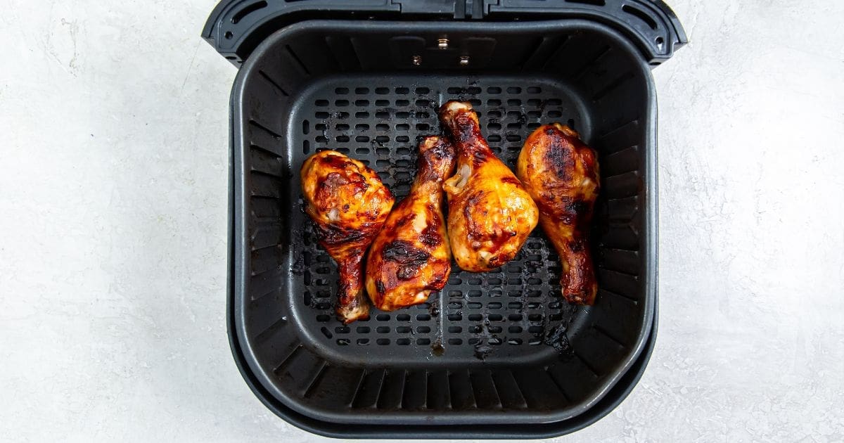 Air Fryer BBQ Chicken Legs a white plate with parsley.