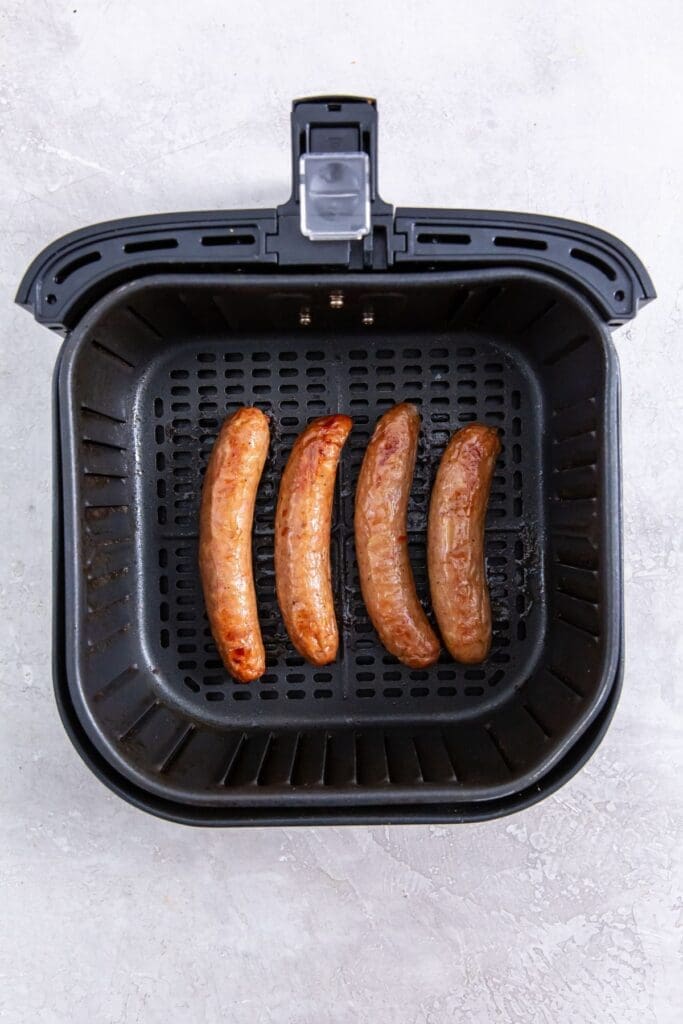 black air fryer with cooked chicken insider
