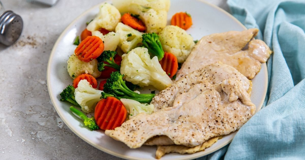 Chicken Air Fryer Meals a Plate of Air Fryer Thin Sliced Chicken Breast with Steamed Veggies