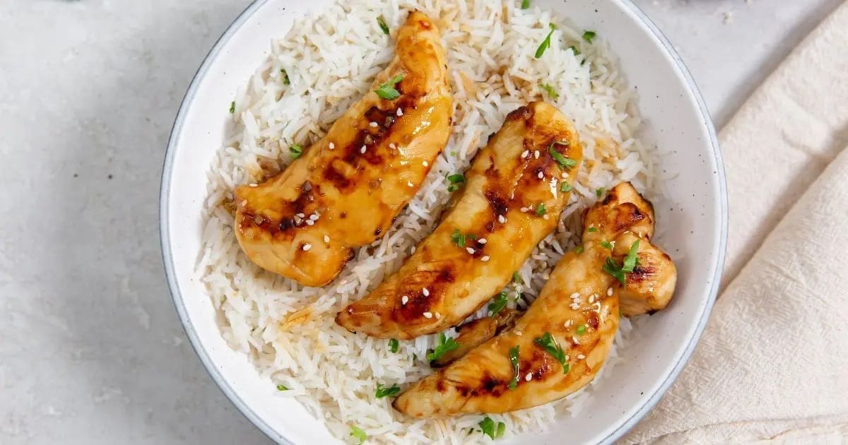 Kid-Approved Chicken Air Fryer Recipes a Bowl of Rice Topped with Easy Air Fryer Teriyaki Chicken Tenders