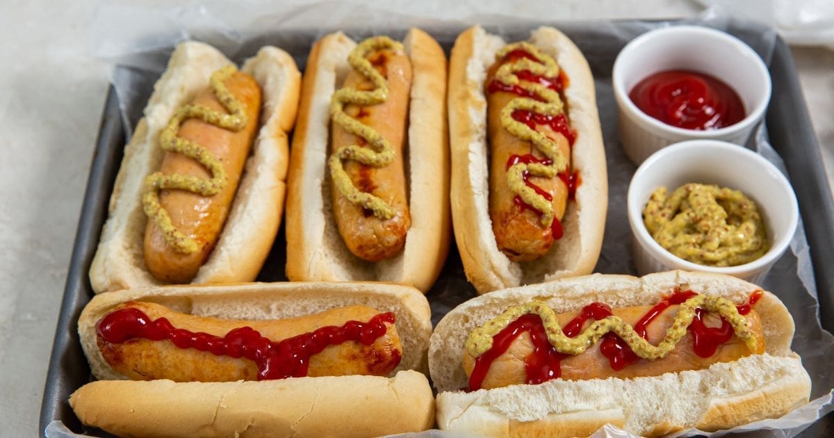 Chicken Recipes So Good a Serving Platter of Easy Air Fryer Trader Joe's Chicken Sausage in Hot Dog Buns with Ketchup and Mustard