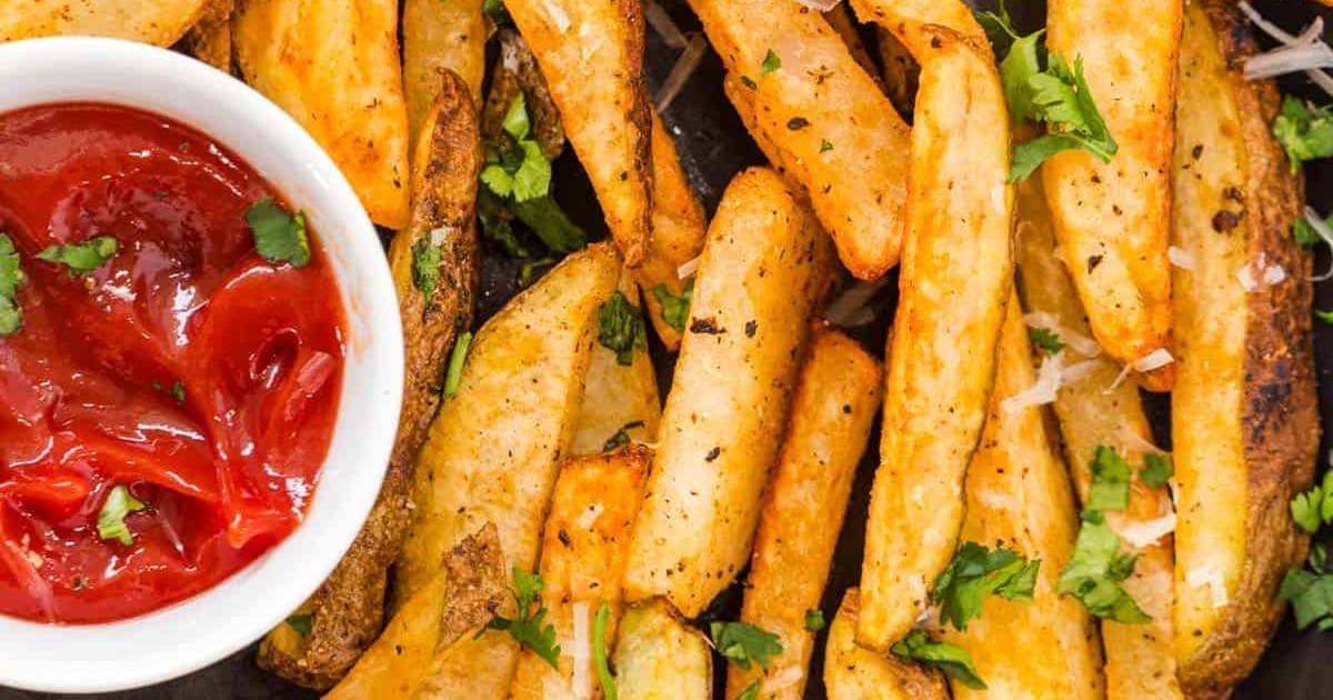 Memorial Day Air Fryer Recipes Close Up of Air Fryer French Fries with a Small Ramekin of Ketchup