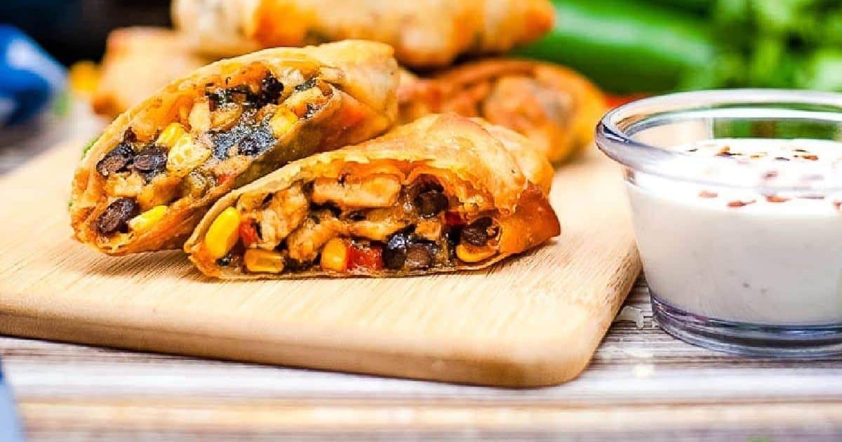 Air Fryer Restaurant Recipes Close Up of Chili's Southwest Egg Rolls on a Wooden Cutting Board