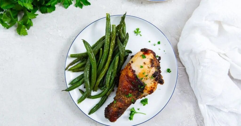 Chicken Legs in Air Fryer Recipes Crispy Air Fryer Ranch Chicken Legs on a Plate with Green Beans
